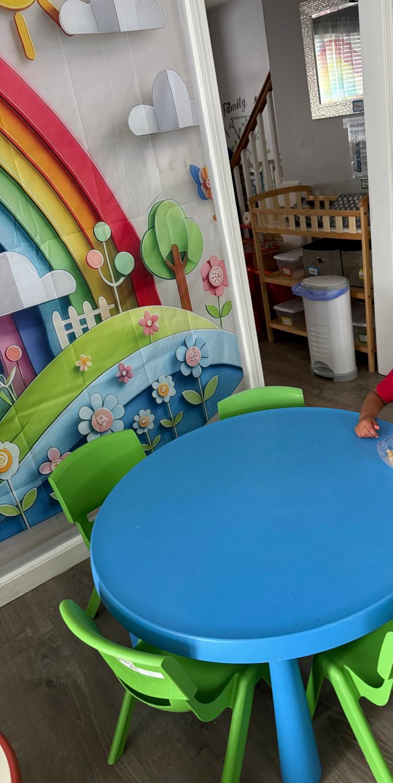Table area with rainbow wall decor and educational activities