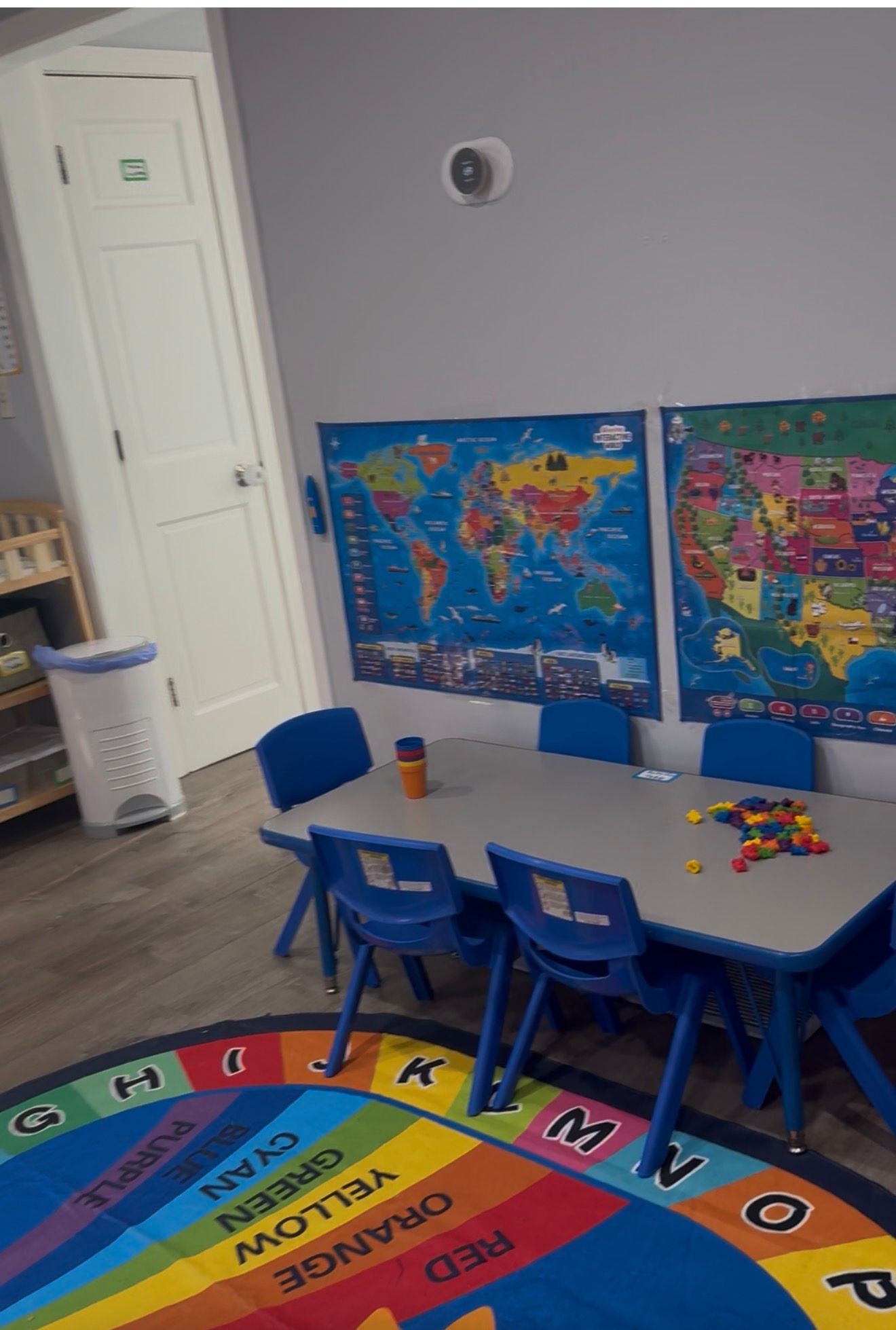 Learning space with tables, chairs, and world maps